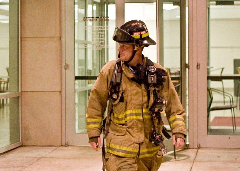 Michael Gulledge/THE STANDARD -- Firefighter Larry Fighter walks out of the Plaster Student Union Tuesday after a gas leak evacuated the building. The building reopened by 10 P.M.