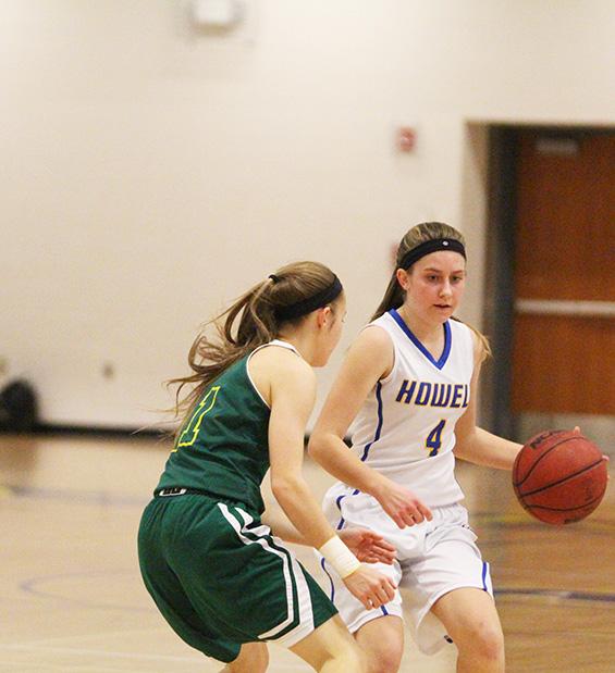 The Lady Vikings basketball team played Rock Bridge, Jan. 6. Sophomore Courtney Marx dribbles past the opposing team to try to pass the ball. The Lady Vikings won with a score of 42-34.