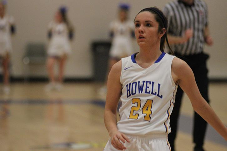 Feb. 9, Howell vs Troy at Howells main gym, Leah Ellege watches her 3 point shot fall in the basket as she makes 4 3 point shots in the game . I felt a sense of urgency before the game, and just felt good today. Ellege said.