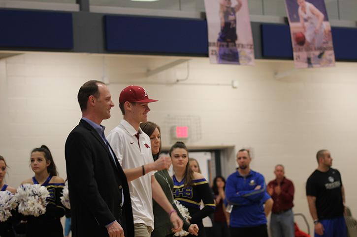 Feb. 3, at signing day at Howells main gym, Jake Kostyshock shows his joy as he signs a letter of intent to the University of Arkansas to play baseball. Both of my parents went there, and I knew I wanted to go there, but only if I was going to be able to play baseball.Kostyshock said.