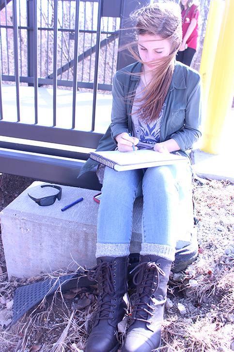 Taking class outside on Feb. 19, drawing 1 goes  outside to find something unique to sketch. Sophomore Emily Yovich said
Life is like a box of chocolates, you never know what youre going to do in drawing class.
​