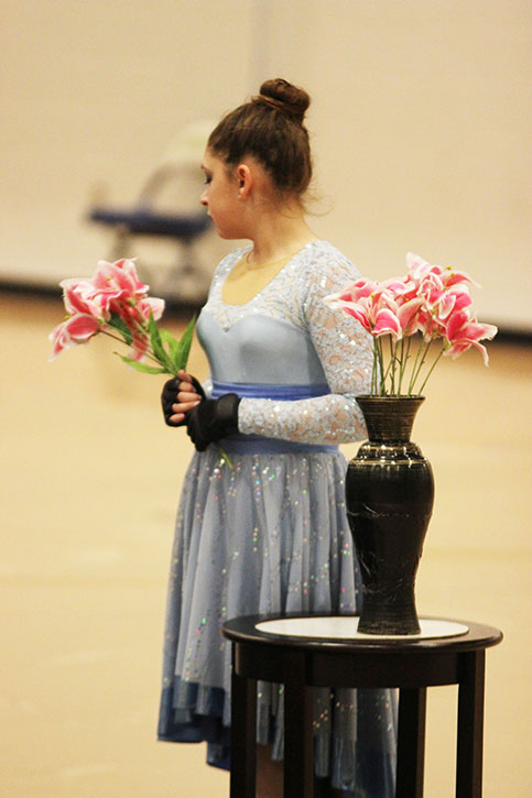 Before performancing the winter guard show Where Are You, March 3, freshman Eva Voss gets set in position. 