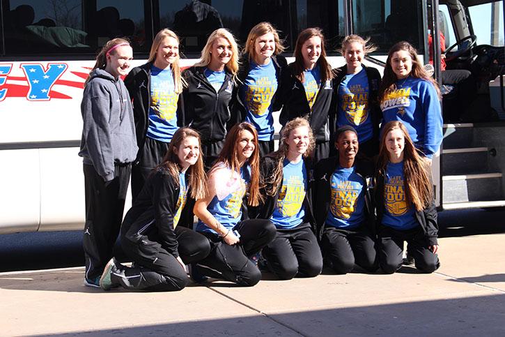 Before loading on the bus, girls varsity basketball team stopped for a picture before heading to Mizzou March 17, 2016 for the state championship game.