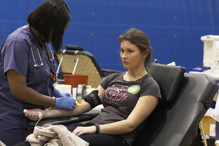 While being prep for her blood donation, April 8, senior Ellie Biever looks away in anticipation.