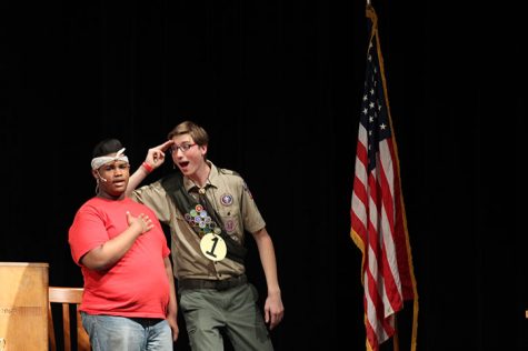 A pledge allegiance, seniors Malcolm Hudson and Matthew Kiewiet salute the flag in the spring play on April 15.