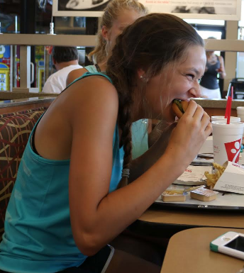 Sophomore Becca Zile enjoys a sandwich during the Chick-Fil-A fundraiser for the girls tennis team, Aug. 18. Chick-fil-a wasnt just used to raise money, it was also a team bonding event, Zile said. 