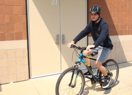Sophomore Dylan Enyart rides his bike during Fit for Life gym class Aug. 30. 
