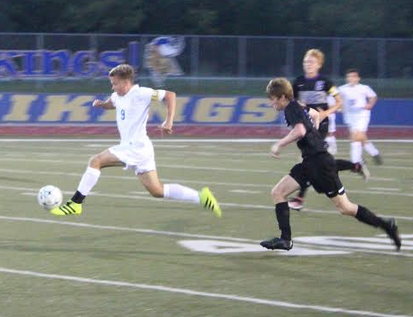 Forward, senior Zach Eyler takes the ball down the field. "I felt like it was a good team performance, it was good to bounce back from two losses to just come together as a team to win the game," Eyler said. 