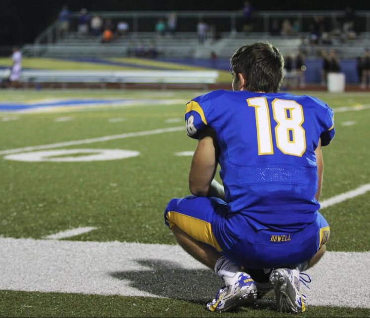 Sept. 12,  Sophomore Aidan Montgomery watches from the sideline as the JV team end the fourth quarter of the game against Troy. The JV football team swept the game 39-15. 