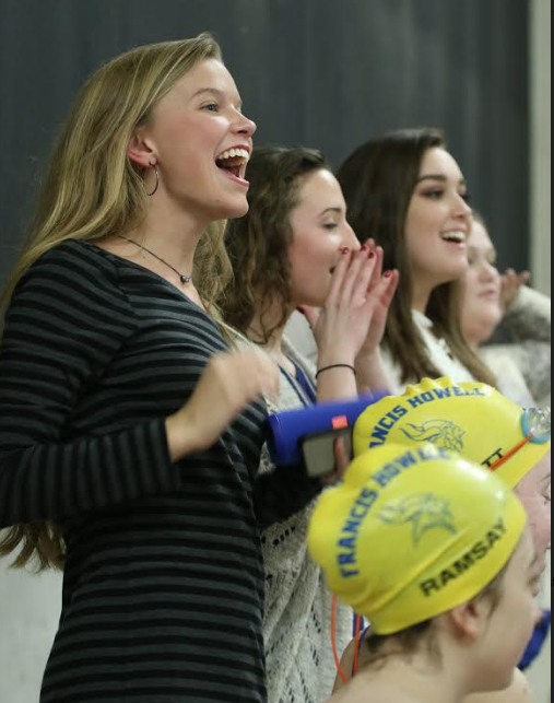Senior Alyssa Juris, Kelly Schroeder, and Lilly Apperson lead the team cheer during their senior night meet against Liberty, Jan. 18. I love being able to share my passion for swimming, and hope to make them feel more welcomed, Juris said. Howell won 110-78. 
