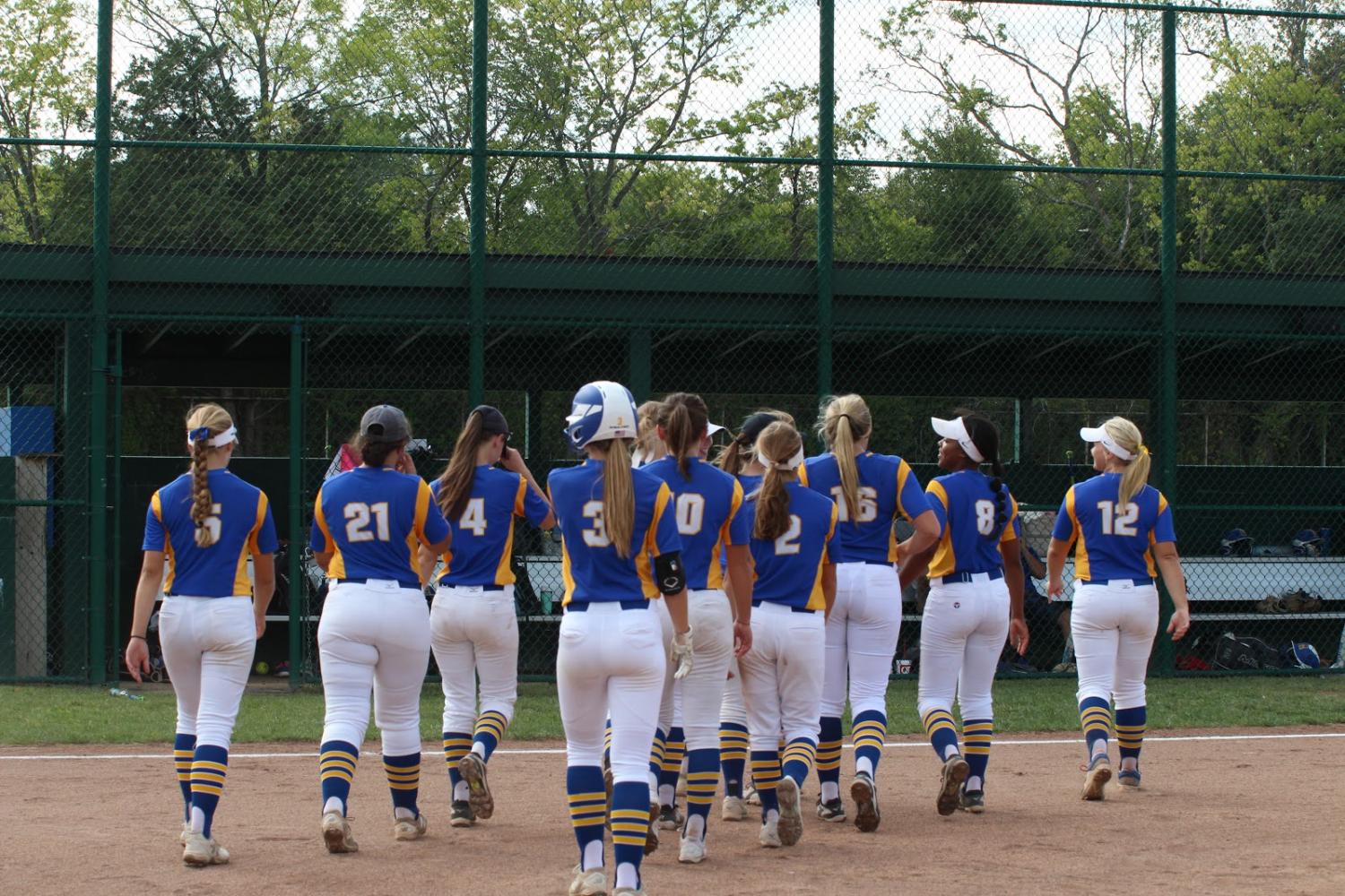 After defeating Sullivan 3-0 in the first game, varsity teammates walk off the field together. Senior Whitney Boschert contributed to the win pitching two out of three innings. 