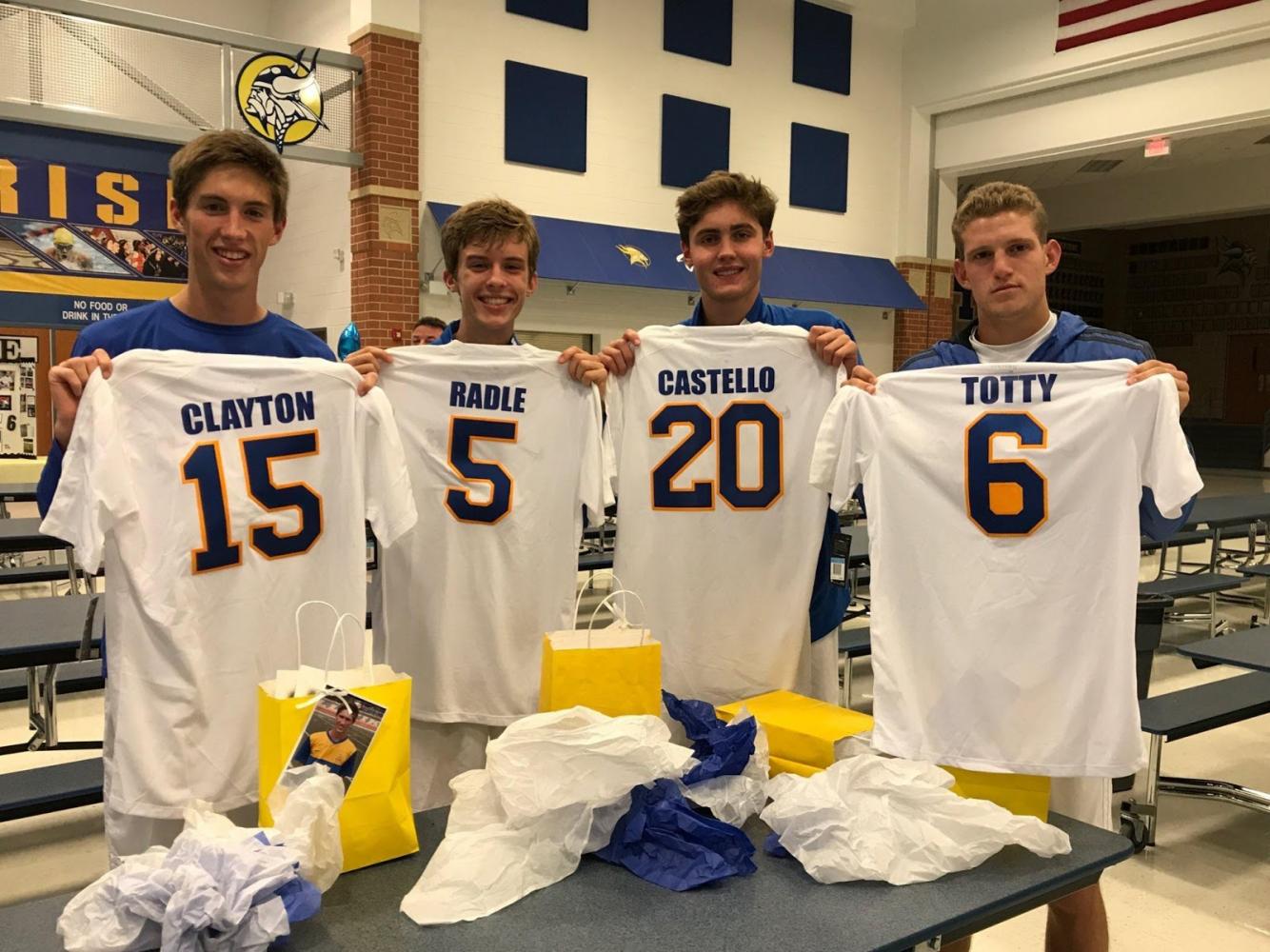Seniors Will Clayton, Eric Radle, Caden Castello, and Jake Totty receive senior night gifts after defeating Howell North 3-0 Oct. 10. This win gives the Vikings an undefeated record in their conference. All four seniors are starters on varsity.
-Photo credited to @ajdeal16