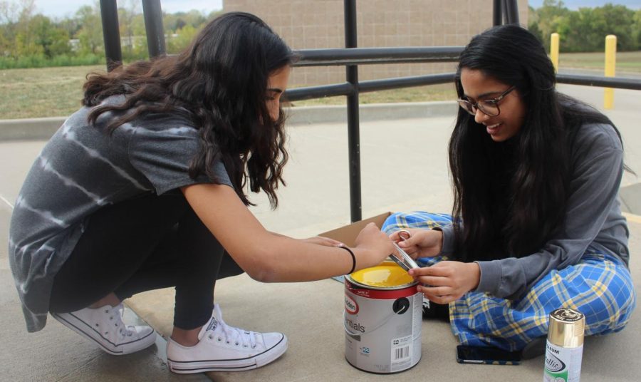 Tuesday, Oct. 3, Viking Way members work on the finishing touches of the club’s homecoming spirit board. Senior Mansi Patel and junior Jasmine Bhangu open a can of yellow paint for the popcorn featured on the movie theatre themed board. “Taking the time after school to work on the spirit board was so fun because I got to laugh and make a mess with my friends, and in the end, the board turned out great,” Bhangu said. The Viking Way project won the homecoming spirit board contest after the Powder Puff football game the next day. 