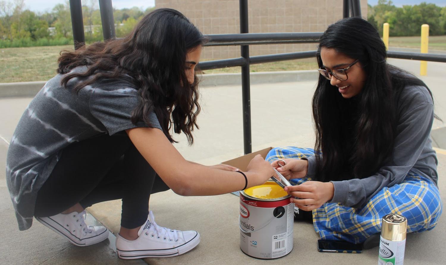 Tuesday, Oct. 3, Viking Way members work on the finishing touches of the club’s homecoming spirit board. Senior Mansi Patel and junior Jasmine Bhangu open a can of yellow paint for the popcorn featured on the movie theatre themed board. “Taking the time after school to work on the spirit board was so fun because I got to laugh and make a mess with my friends, and in the end, the board turned out great,” Bhangu said. The Viking Way project won the homecoming spirit board contest after the Powder Puff football game the next day.